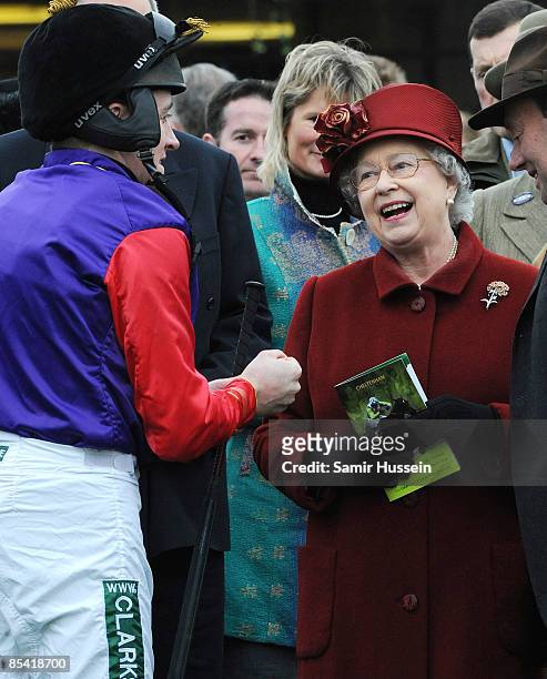 Queen Elizabeth II meets Barry Geraghty, jockey of her horse Barbers Shop, in the parade ring on Gold Cup day at the Cheltenham Festival on March 13,...