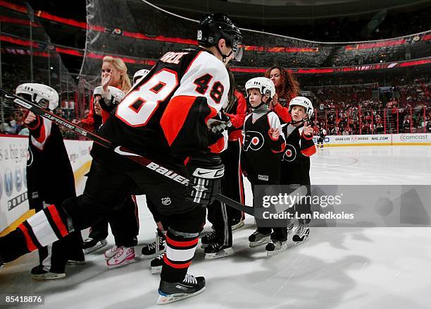 Danny Briere of the Philadelphia Flyers skates past some children of the Flyers Hi-Five Club prior to the start of the game against the Washington...