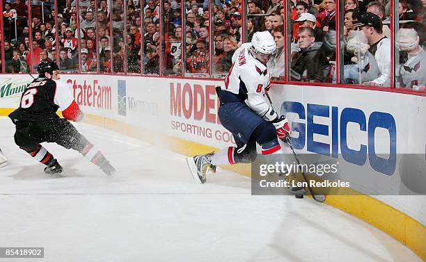 Alex Ovechkin of the Washington Capitals battles for the puck along the boards against Randy Jones of the Philadelphia Flyers on March 12, 2009 at...