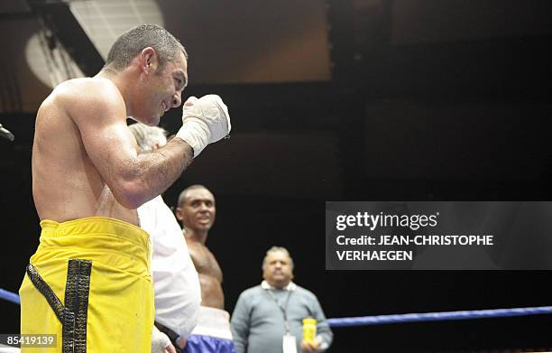 French former super-bantamweight WBA champion Mahyar Monshipour celebrates after defeating Venezuelian Felix Machado during their super-bantamweight...