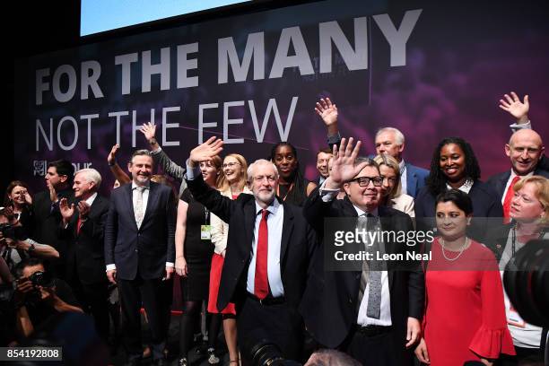 Labour party leader Jeremy Corbyn, Deputy Labour party leader Tom Watson and Shadow Attorney General Shami Chakrabarti wave to delegates in the main...