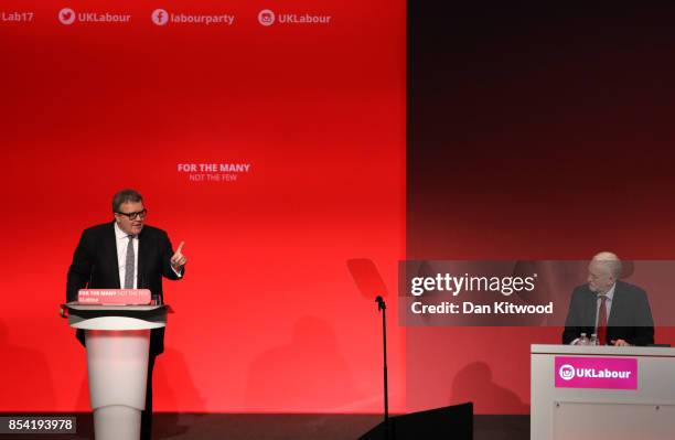 Deputy Labour party leader Tom Watson speaks to delegates in the main hall as Labour party leader Jeremy Corbyn looks on, on day three of the annual...