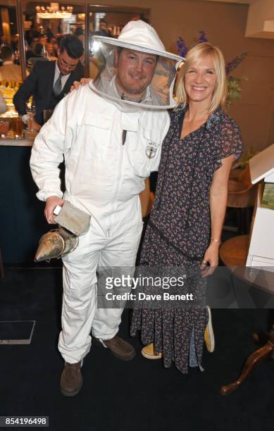Jo Whiley poses with a beekeeper at the launch of Warner Edwards' Honeybee Gin with the Royal Horticultural Society at Fortnum & Mason on September...
