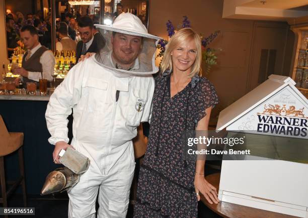 Jo Whiley poses with a beekeeper at the launch of Warner Edwards' Honeybee Gin with the Royal Horticultural Society at Fortnum & Mason on September...