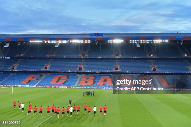 Benfica's players wamr up during a training session on the eve of the UEFA Champions league Group A football match between FC Basel 1893 and SL...