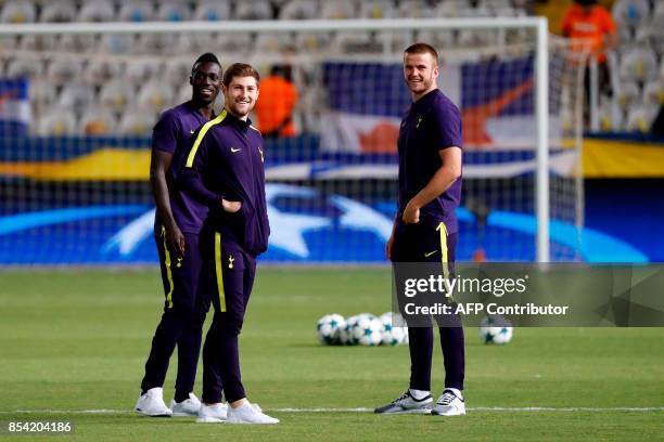 Tottenham Hotspur's Colombian defender Davinson Sanchez, Welsh defender Ben Davies and English defender Eric Dier gather on the pitch ahead of their...