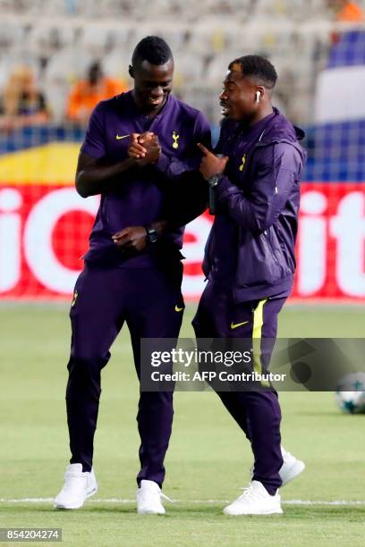 Tottenham Hotspur's Colombian defender Davinson Sanchez speaks with French defender Serge Aurier ahead of their UEFA Champions League football match...