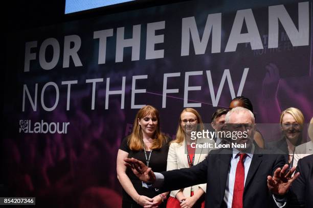 Labour Party leader Jeremy Corbyn gestures to delegates as he stands with members of the Shadow Cabinet at the end of the third day of the Labour...