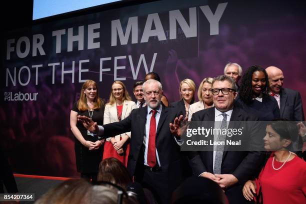 Labour Party leader Jeremy Corbyn gestures to delegates as he stands with members of the Shadow Cabinet at the end of the third day of the Labour...