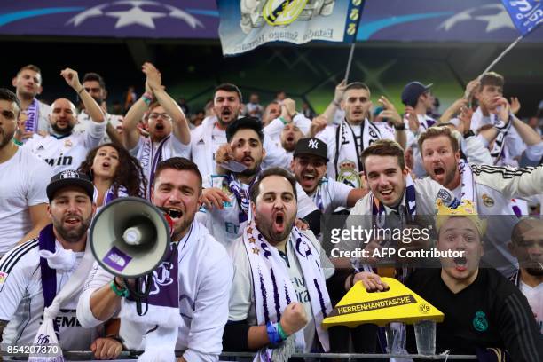 Supporters of Real Madrid cheer prior to the UEFA Champions League Group H football match BVB Borussia Dortmund v Real Madrid in Dortmund, western...