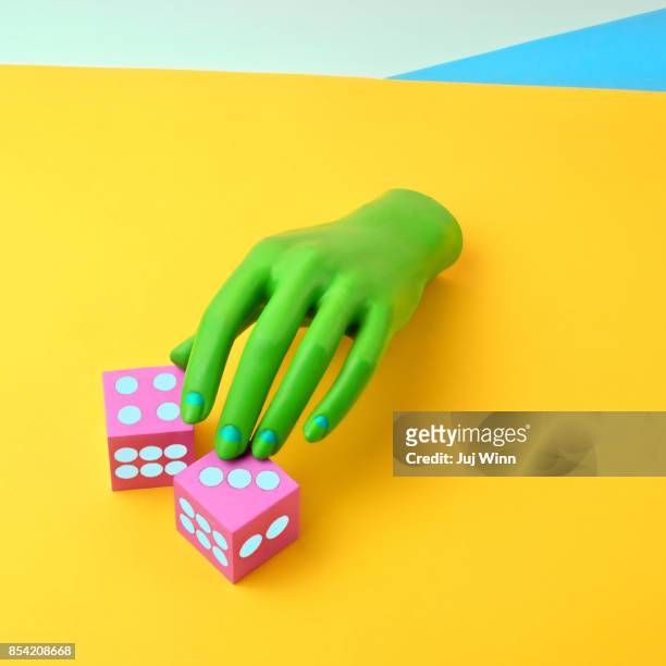 green mannequin hand with dice - colour block stock pictures, royalty-free photos & images
