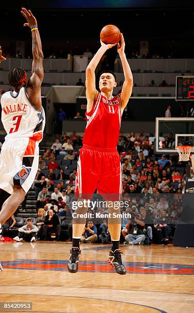Yao Ming of the Houston Rockets makes first 3-pointer in 6 years against Gerald Wallace of the Charlotte Bobcats on March 13, 2009 at the Time Warner...