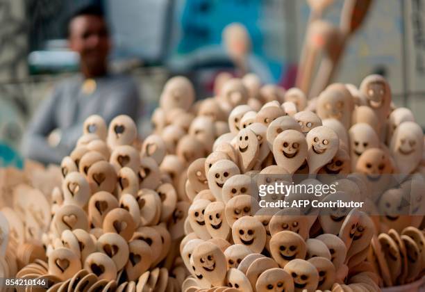 Vendor sells wooden spoons at Naschmarkt market in Vienna, Austria on September 25, 2017. / AFP PHOTO / JOE KLAMAR