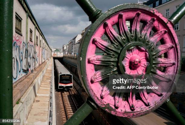Subway train U4 passes by Naschmarkt market in Vienna, Austria on September 25, 2017. / AFP PHOTO / JOE KLAMAR