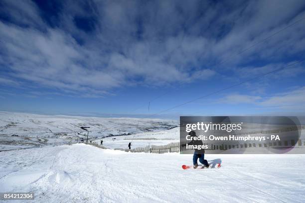 Snow boarder enjoys the glorious conditions at the Yad Moss ski slope in Alston, near Cumbria.