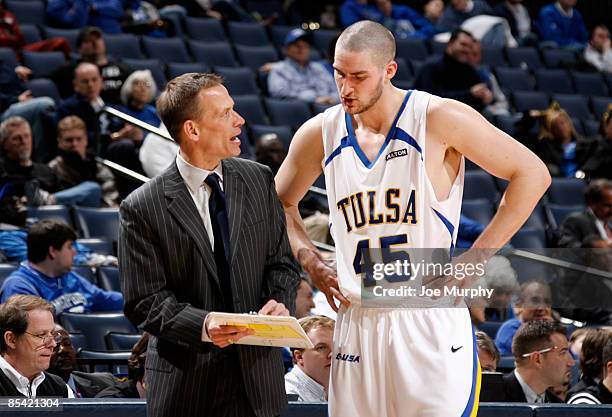 Doug Wojcik, head coach of the Tulsa Golden Hurricane talks with Sam Mitchell during a game against the UAB Blazers during the Semifinals of the...