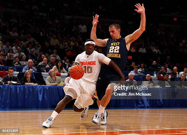 Jonny Flynn of the Syracuse Orange handles the ball against Alex Ruoff of the West Virginia Mountaineers during the semifinal round of the Big East...