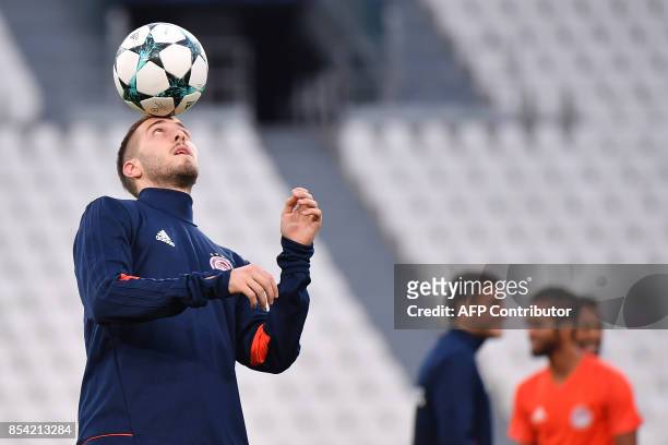 Olympiacos' midfielder from Greece Kostas Fortounis takes part in a training session on the eve of the UEFA Champions League football match Juventus...