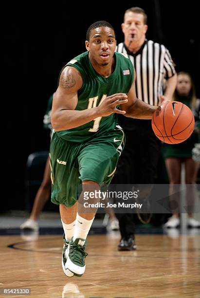 Aaron Johnson of the UAB Blazers brings the ball upcourt against the Tulsa Golden Hurricane during the Semifinals of the Conference USA Basketball...