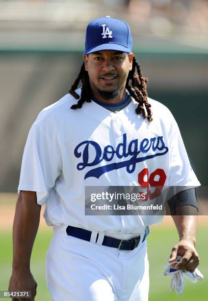 Manny Ramirez of the Los Angeles Dodgers walks along the field before a Spring Training game against the Texas Rangers on March 13, 2009 at Camelback...