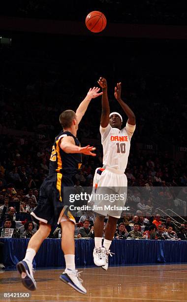 Jonny Flynn of the Syracuse Orange shoots over Alex Ruoff of the West Virginia Mountaineers during the semifinal round of the Big East Tournament at...