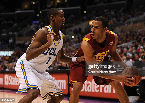 Guard Dwight Lewis of the USC Trojans looks to drive against guard Malcolm Lee of the UCLA Bruins during their game in the Pacific Life Pac-10 Men's...