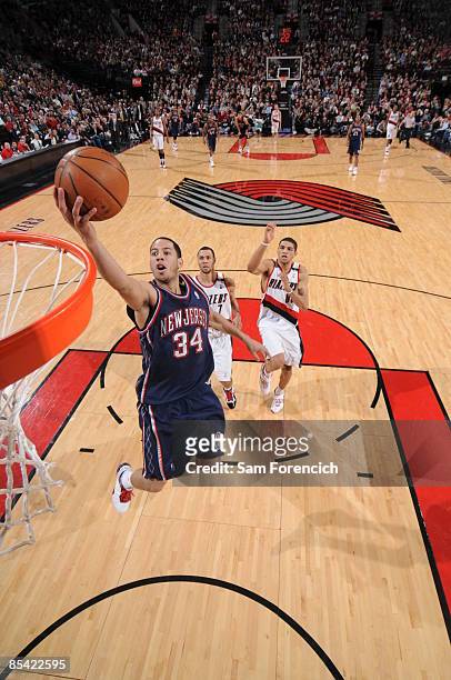 Devin Harris of the New Jersey Nets lays it up during a game against the Portland Trail Blazers on March 13, 2009 at the Rose Garden Arena in...