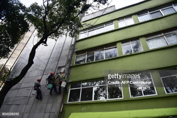 Workers inspect and try to repair a building damaged by the September 19 magnitude 7.1 quake that struck central Mexico, at Roma Norte neighbourhood...