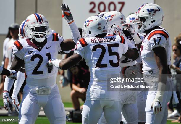 Safety Reggie Floyd, safety Deon Newsome, and defensive back Divine Deablo of the Virginia Tech Hokies huddle prior to the game against the Old...