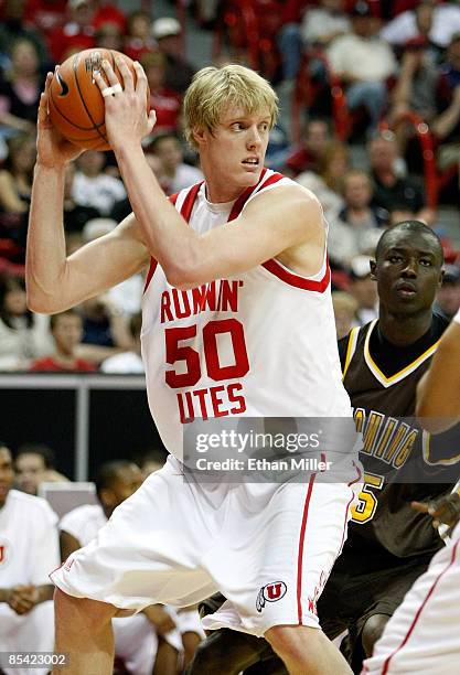 Luke Nevill of the Utah Utes looks to pass in front of Djibril Thiam of the Wyoming Cowboys during a semifinal game of the Conoco Mountain West...