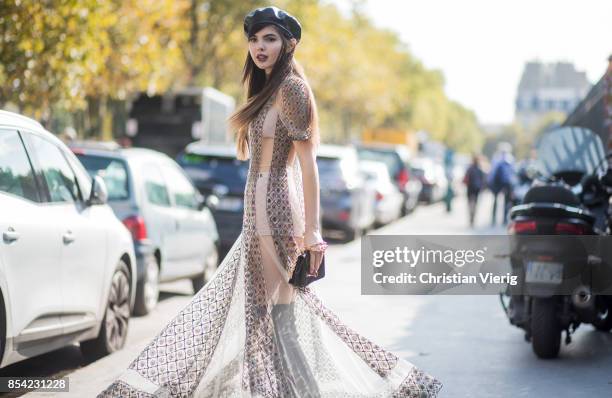 Doina Ciobanu wearing beret, sheer dress is seen outside Dior during Paris Fashion Week Spring/Summer 2018 on September 26, 2017 in Paris, France.