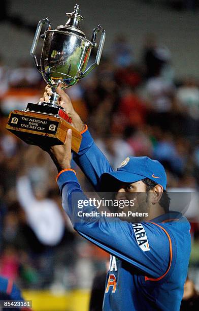 Mahendra Singh Dhoni of India holds up the National Bank trophy after wining the series 3-1 after the fifth one day international match between the...