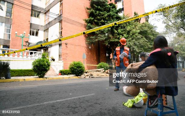 People remove belongings from their apartments at a building damaged by the magnitude 7.1 quake that struck central Mexico a week ago, in Mexico City...