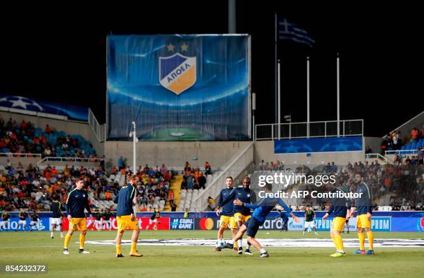 Apoel FC players warm up ahead of their UEFA Champions League football match against Tottenham Hotspur at the GSP Stadium in the Cypriot capital,...