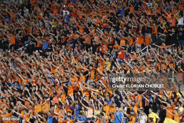Apoel FC's fans cheer ahead of the UEFA Champions League football match between Apoel FC and Tottenham Hotspur at the GSP Stadium in the Cypriot...