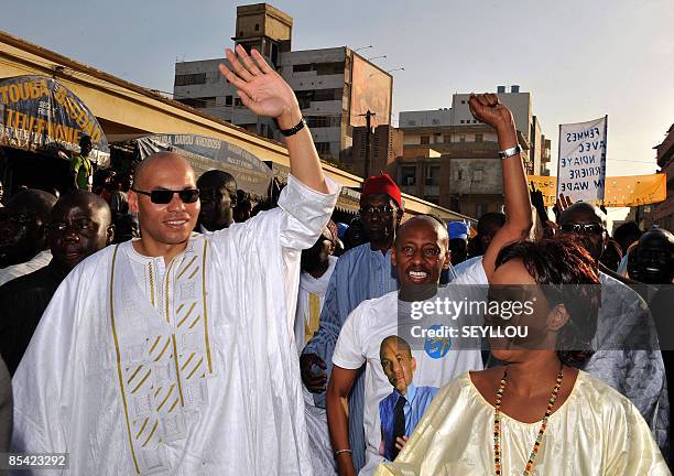 Karim Wade, son of Senegal president Abdoulaye Wade, flanked by his friends Awa Ndiaye et El hadji Dia , waves his supporters in Dakar on March 13,...