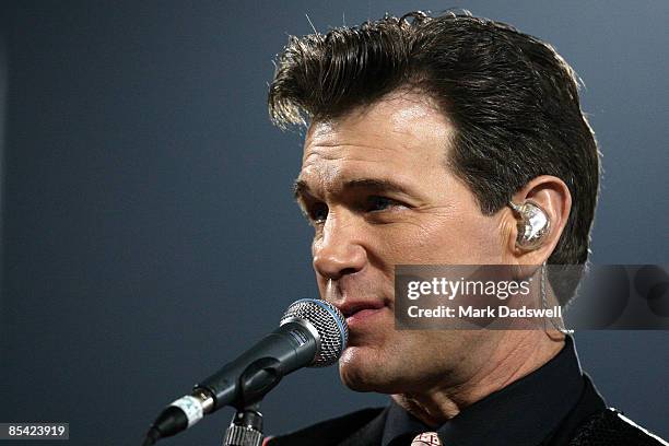 Chris Isaak performs at the half time break during the round one NRL match between the Melbourne Storm and the St George Illawarra Dragons at Olympic...