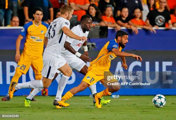 Apoel FC's Norwegian midfielder Ghayas Zahid dribbles with the ball as he is marked by Tottenham Hotspur's English defender Eric Dier and French...