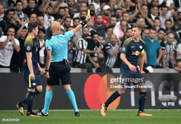 Willi Orban of RB Leipzig is shown a yellow card by referee Sergei Karasev during the UEFA Champions League Group G match between Besiktas and RB...