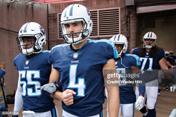 Ryan Succop and Jayon Brown of the Tennessee Titans walk out of the tunnel with arms locked before a game against the Seattle Seahawks at Nissan...