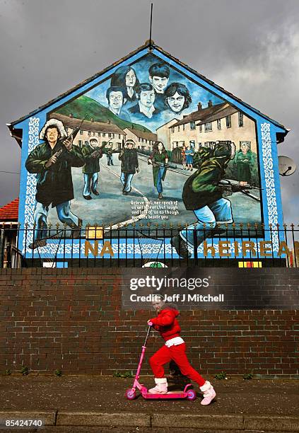 Girl goes past a catholic republican mural in the Ballymurphy estate in Belfast on March 14, 2009 in Northern Ireland. Communities in Northern...
