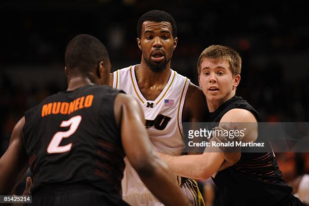 Keiton Page of the Oklahoma State Cowboys and Zaire Taylor of the Missouri Tigers during the Phillips 66 Big 12 Men's Basketball Championship...