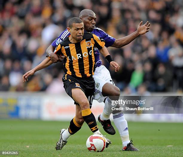 Geovanni of Hull City is challenged by Geremi of Newcastle United during the Barclays Premier League match between Hull City and Newcastle United at...