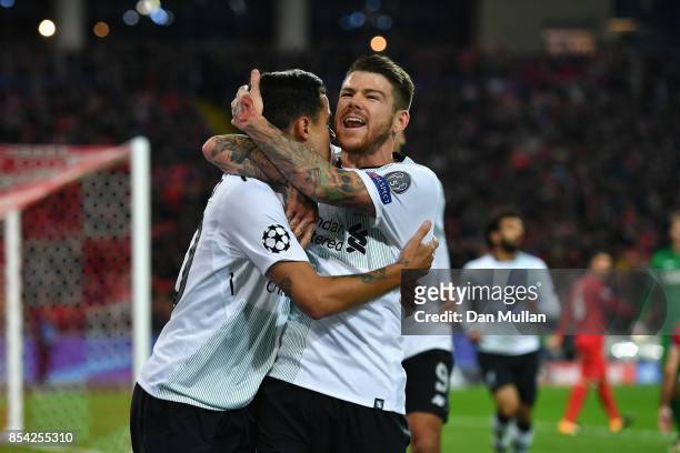 Philippe Coutinho of Liverpool celebrates scoring his sides first goal with Alberto Moreno of Liverpool during the UEFA Champions League group E...