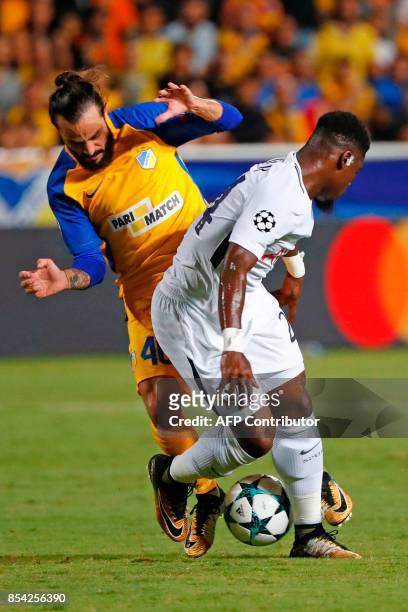 Tottenham Hotspur's French defender Serge Aurier marks Apoel FC's Cypriot midfielder Efstathios Aloneftis during the UEFA Champions League football...