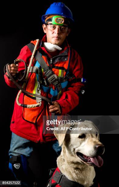 Ruben Sanchez, who volunteered as a rescuer after the 7.1 earthquake that hit Mexico on September 19, poses for pictures with his dog Camilo, in...