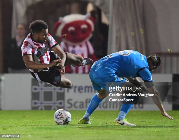 Lincoln City's Matt Green is tackled by Barnet's Michael Nelson during the Sky Bet League Two match between Lincoln City and Barnet at Sincil Bank...