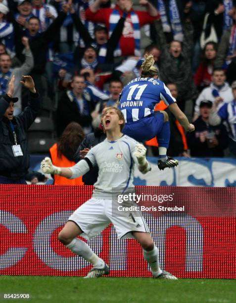 Andrey Voronin of Hertha BSC Berlin celebrates after scoring the first goal while goalkeeper Rene Adler of Bayer Leverkusen shows his frustration...