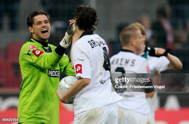 Logan Bailly and Roel Brouwers of M'gladbach celebrate after winning the Bundesliga match between 1. FC Koeln and Borussia Moenchengladbach at the...