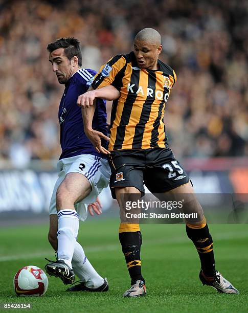 Jose Enrique of Newcastle United tangles with Daniel Cousin of Hull City during the Barclays Premier League match between Hull City and Newcastle...